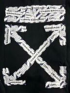 Black hoodie with large V-shaped CABIN BAGGAGE text print and scattered labels.