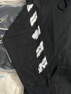 Black hoodie sleeve with vertical CABIN BAGGAGE label stripe