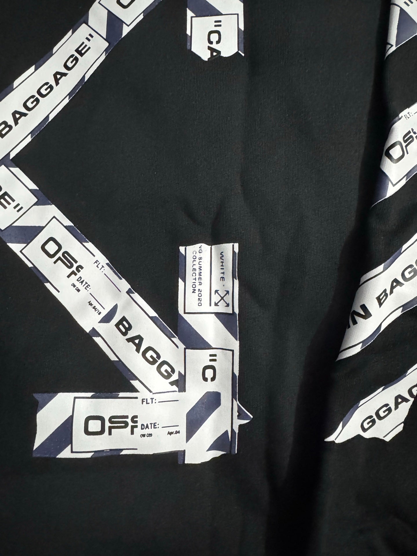 Black hoodie close-up of CABIN BAGGAGE and OFFS printed label details