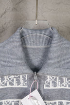 Grey knit sweater top with ribbed collar and cuffs, monogram band along zipper