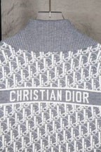 Grey knit sweater with Christian Dior logo across chest and allover monogram pattern