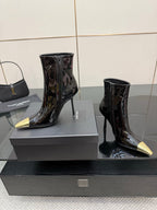 Black patent ankle boots with pointed gold heels, two-pair view on display