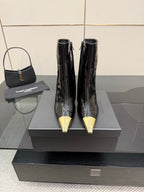 Black patent leather ankle boots for women with pointed gold stiletto heels