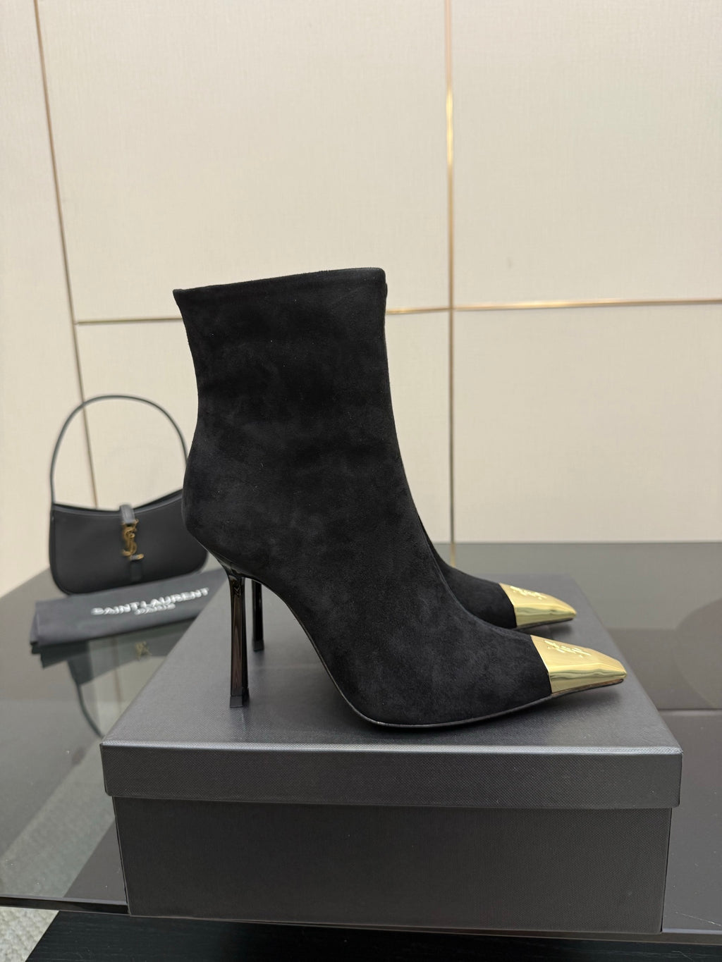 YSL women’s black suede stiletto heeled boots with pointed gold-tone toe caps