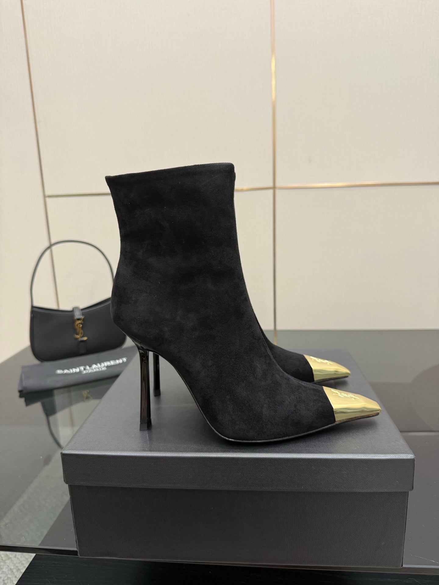YSL women’s black suede stiletto heeled boots with pointed gold-tone toe caps