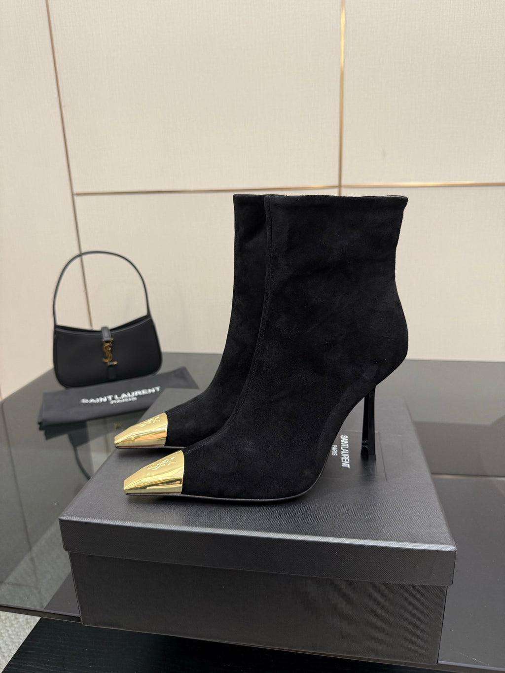 YSL women’s black suede ankle boots with pointed gold-tone toe and stiletto heel