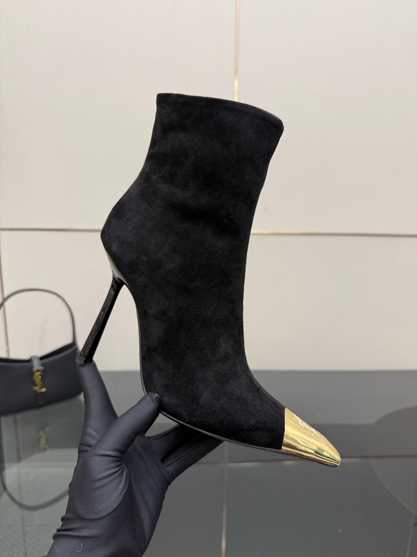 YSL women’s black suede high-heel boots with pointed gold-tone toe caps