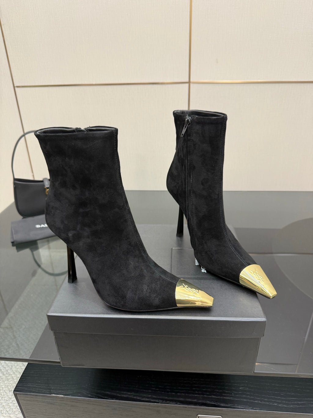YSL women’s black suede heeled boots with pointed gold-tone toe detail