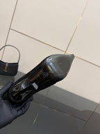 YSL women’s black heeled boot underside view with glossy sole detail