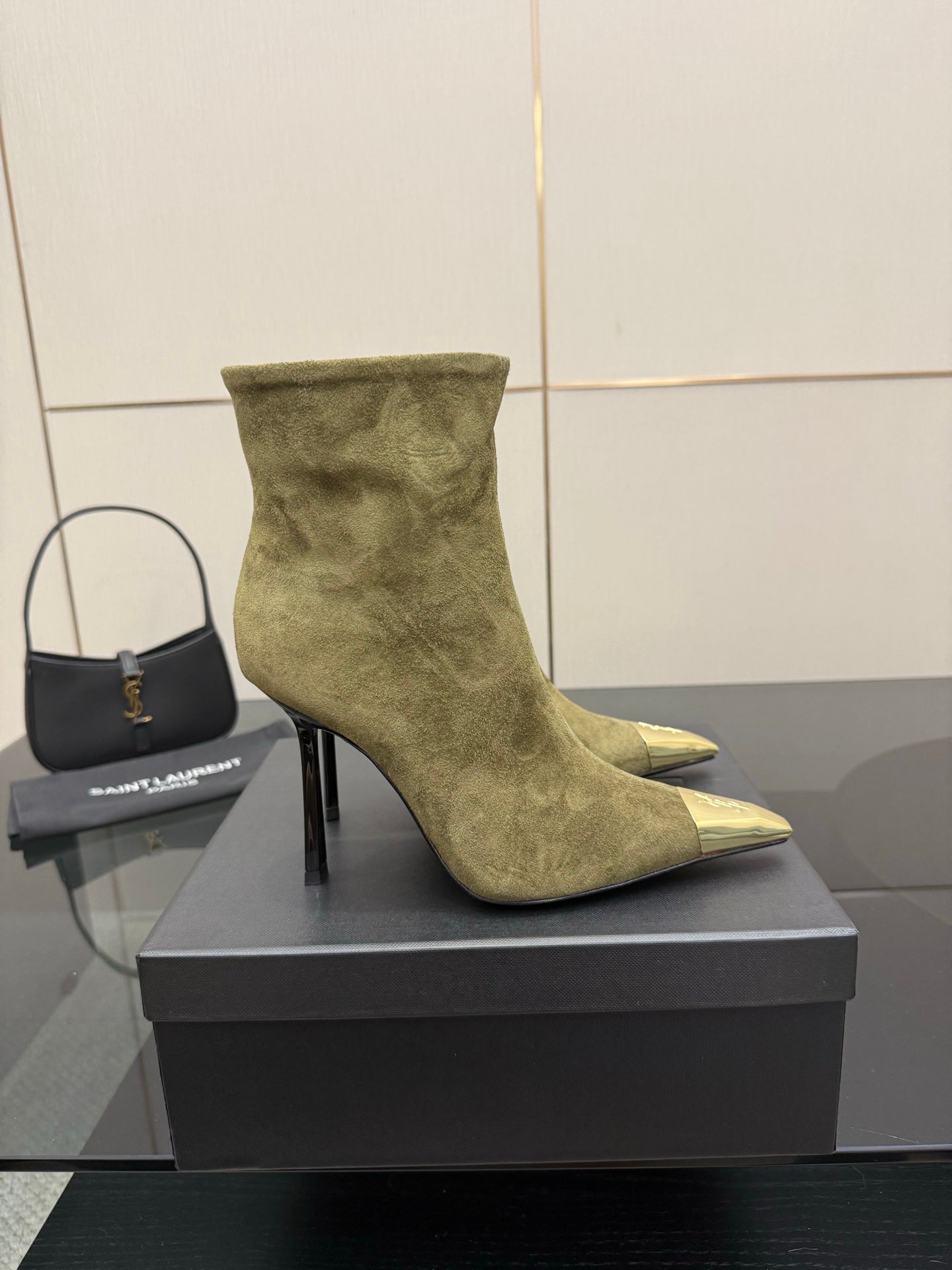 Single ladies’ olive suede ankle boot with pointed gold-tone toe cap and slim black heel