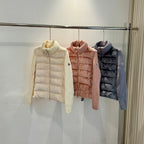 Long puffer jackets in cream, pink, and dark blue, knit collar visible.