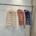 Cream long puffer jacket with knit turtleneck, buttoned front, quilted panels.