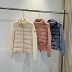 Cream long puffer jacket with knit turtleneck, buttoned front, quilted panels.