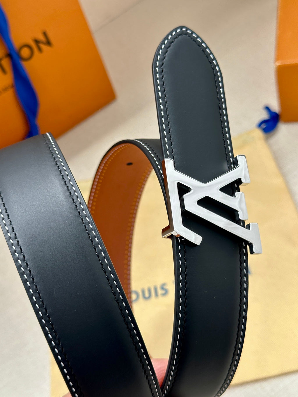 Navy leather belt with gold LV buckle, pointed edge detail
