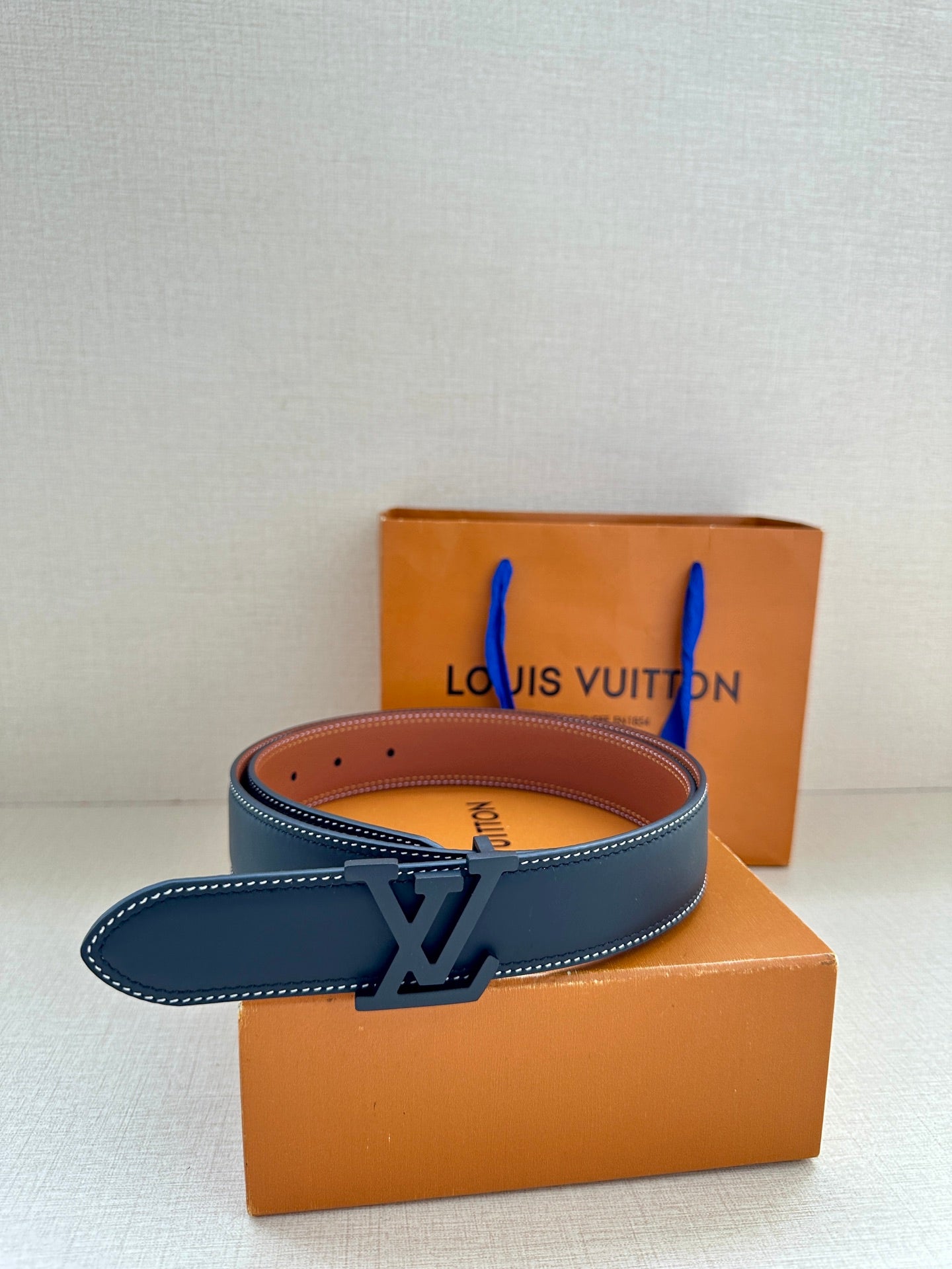Louis Vuitton dark blue leather belt with LV buckle and visible row of holes