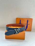 Louis Vuitton leather belt with dark blue strap and silver-toned LV buckle on box