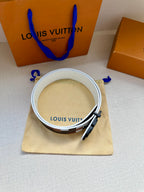 Louis Vuitton belt with white leather reverse, inner branding, and check strap edge.