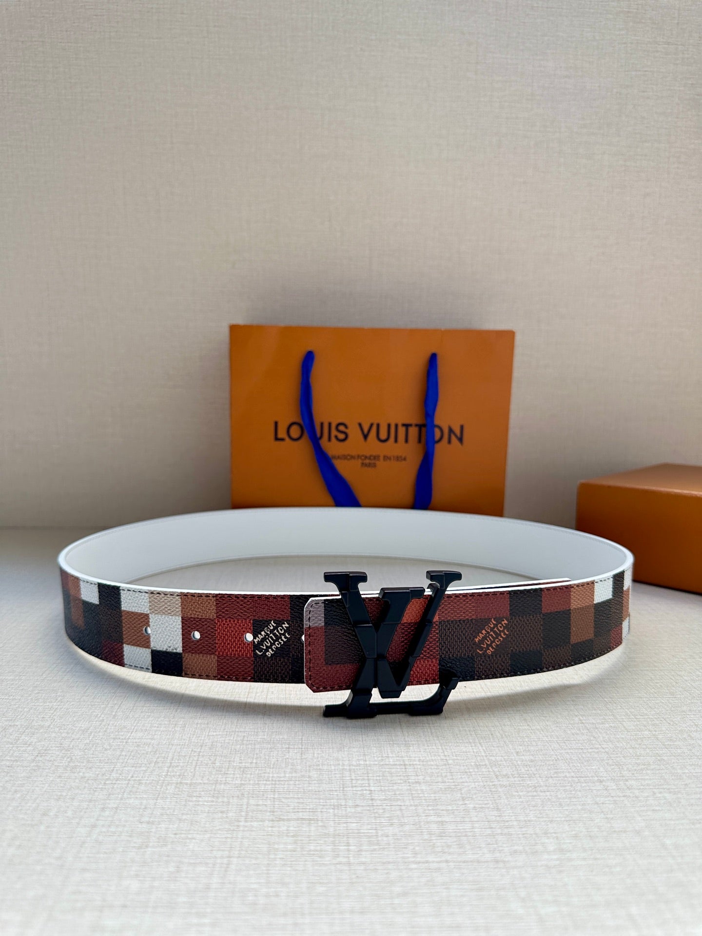 Louis Vuitton belt with multicolor check strap and dark LV buckle, wide width.