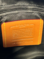 Coah leather backpack bag close-up of orange brand label on inner lining