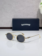 Round metal glasses with gold frames and dark blue tinted lenses