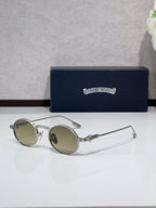 Round metal glasses with silver frames and tan tinted lenses
