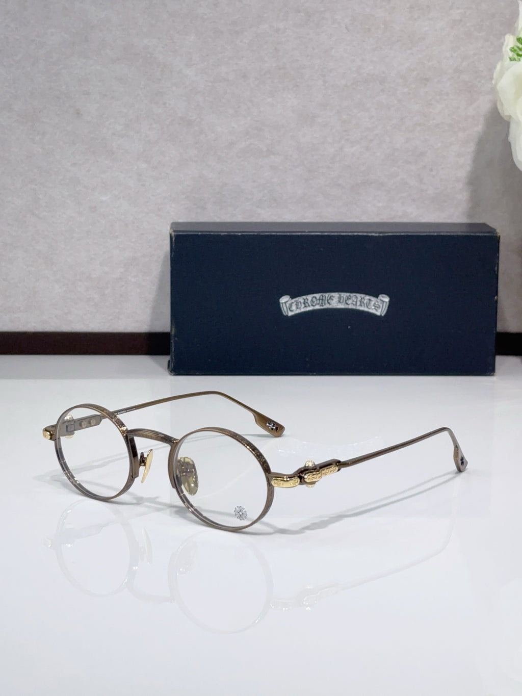 Round metal glasses with bronze frames and clear lenses