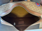 Coah duffel bag interior view with open zipper, fabric lining and brown pocket