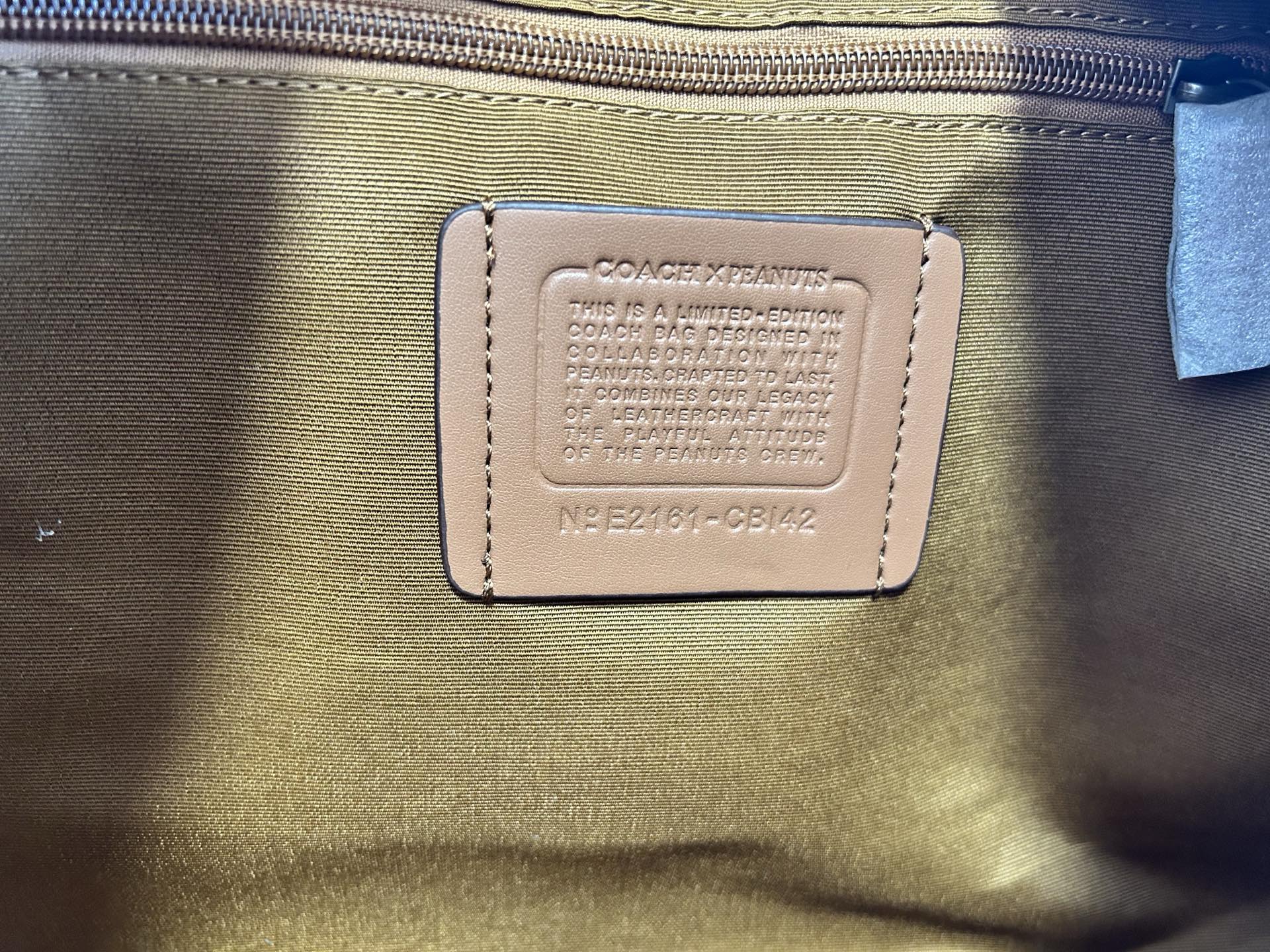 Coah bag interior label patch on lining with printed text and model code