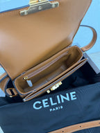 Celine bag opened to show interior pocket; gold-tone zipper and logo hardware at front.