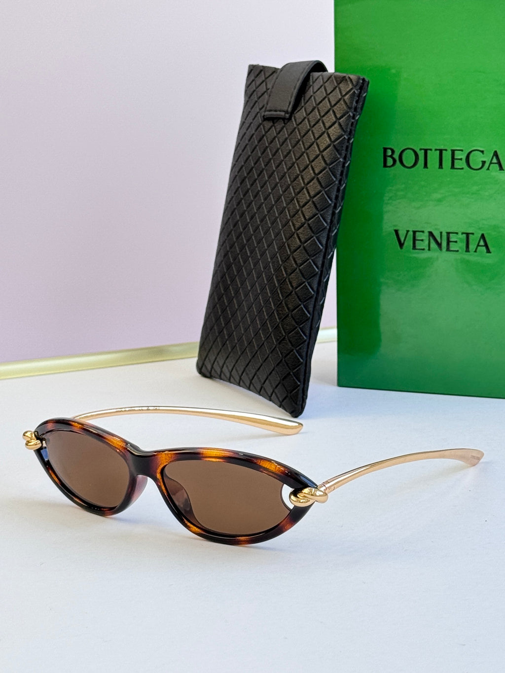 Bottega Veneta tortoiseshell cat-eye glasses with brown-tinted lenses and gold-tone frames