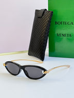 Bottega Veneta black cat-eye glasses with dark gray lenses, gold-tone temples