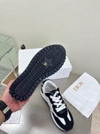 Black low-top sneakers showing textured outsole with contrast sneakers upper