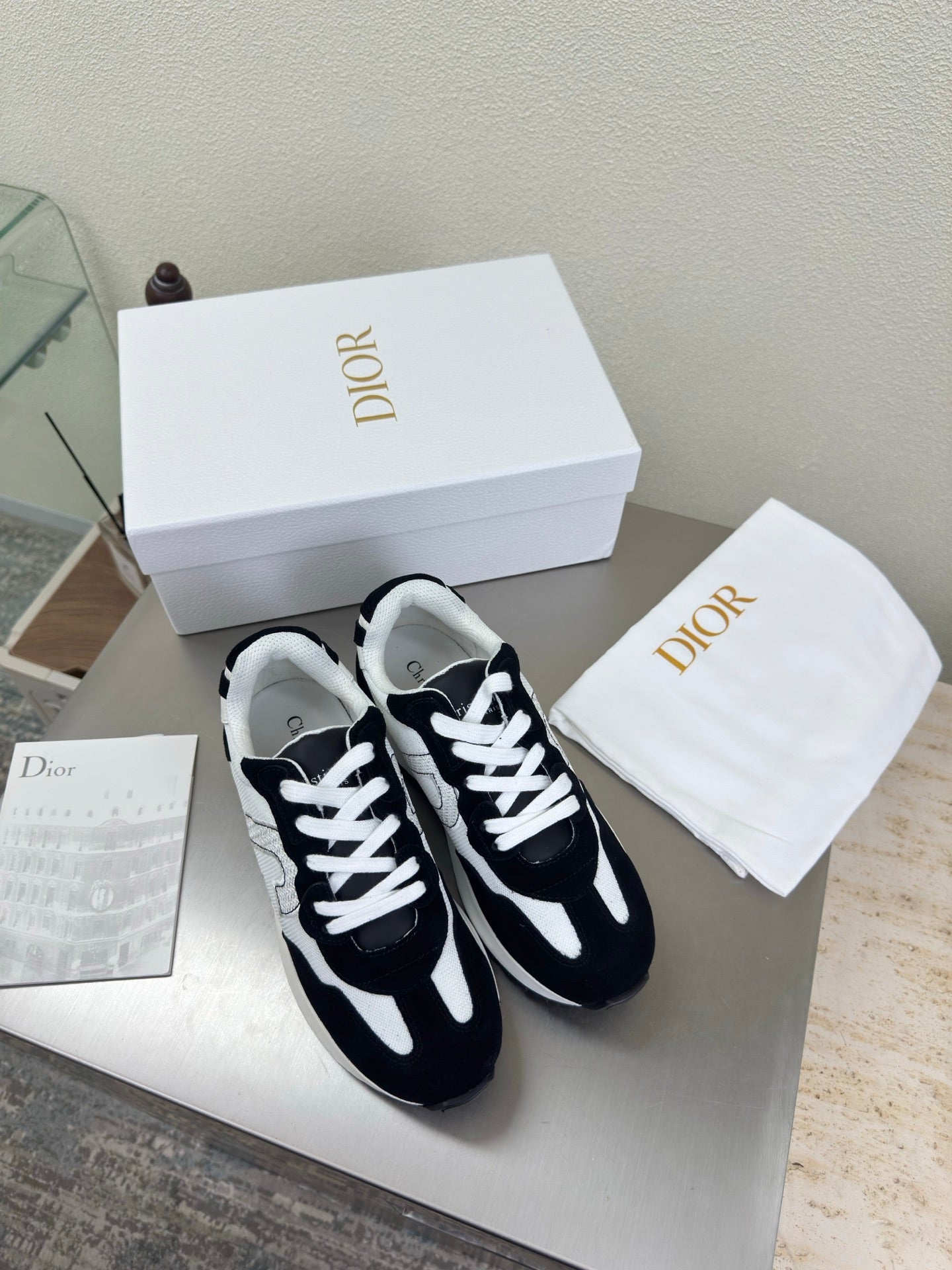 Black and white lace-up sneakers with white laces and contrast side panels