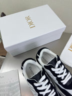 Black and white lace-up sneakers with white laces and Dior logo on the tongue