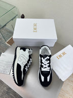 Black and white lace-up sneakers with white laces and rounded toe, side view