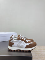 Brown and white sneakers with white laces and logo detail, side angle