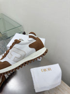 Brown and white sneaker with suede and leather panels, close-up of side and sole tread