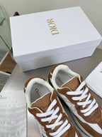Brown and white low-top sneakers with white laces and padded collar, side view close-up