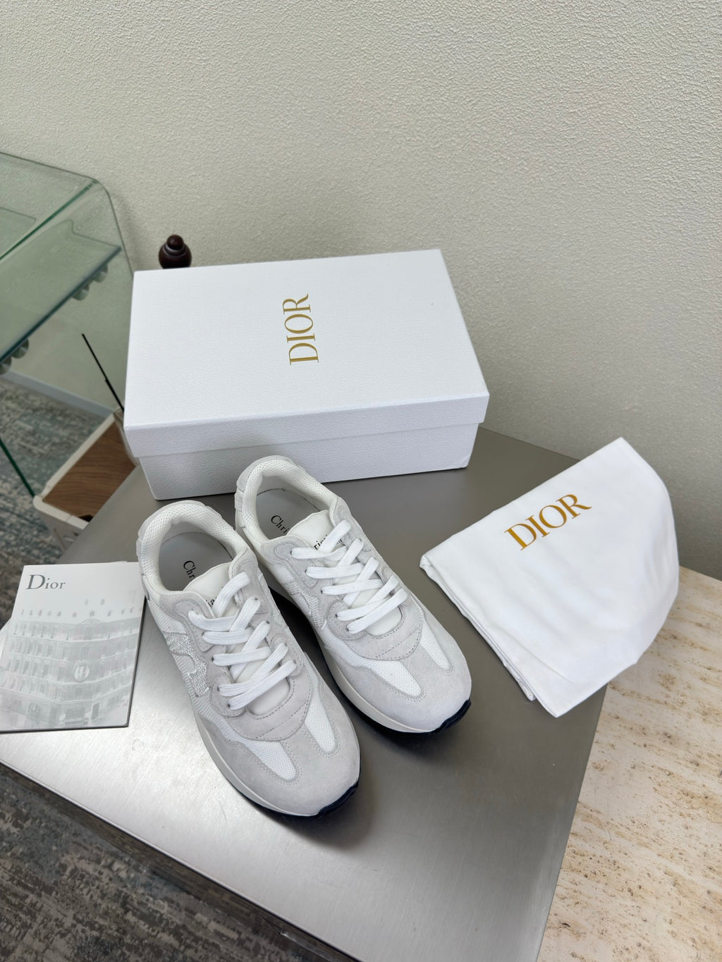 White lace-up sneakers with textured logo detailing and cushioned sole