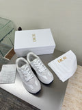 White lace-up sneakers with textured logo detailing and cushioned sole