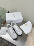 White lace-up sneakers with textured logo detailing and cushioned sole