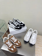 Color-block lace-up sneakers: white and black pair plus brown and tan pair