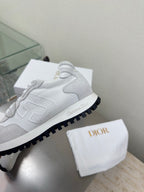 Close-up of light gray lace-up sneaker with chunky outsole and logo trim