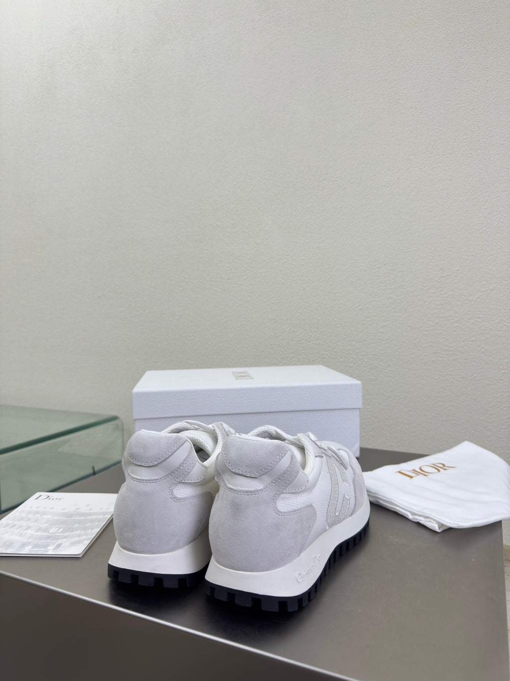 Back view of light gray lace-up sneakers with chunky rubber sole