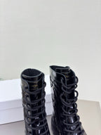 Black lace-up combat boots with padded collars and glossy finish