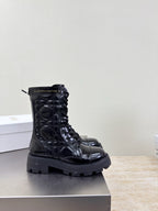 Black glossy lace-up ankle boots with chunky tread sole and eyelets