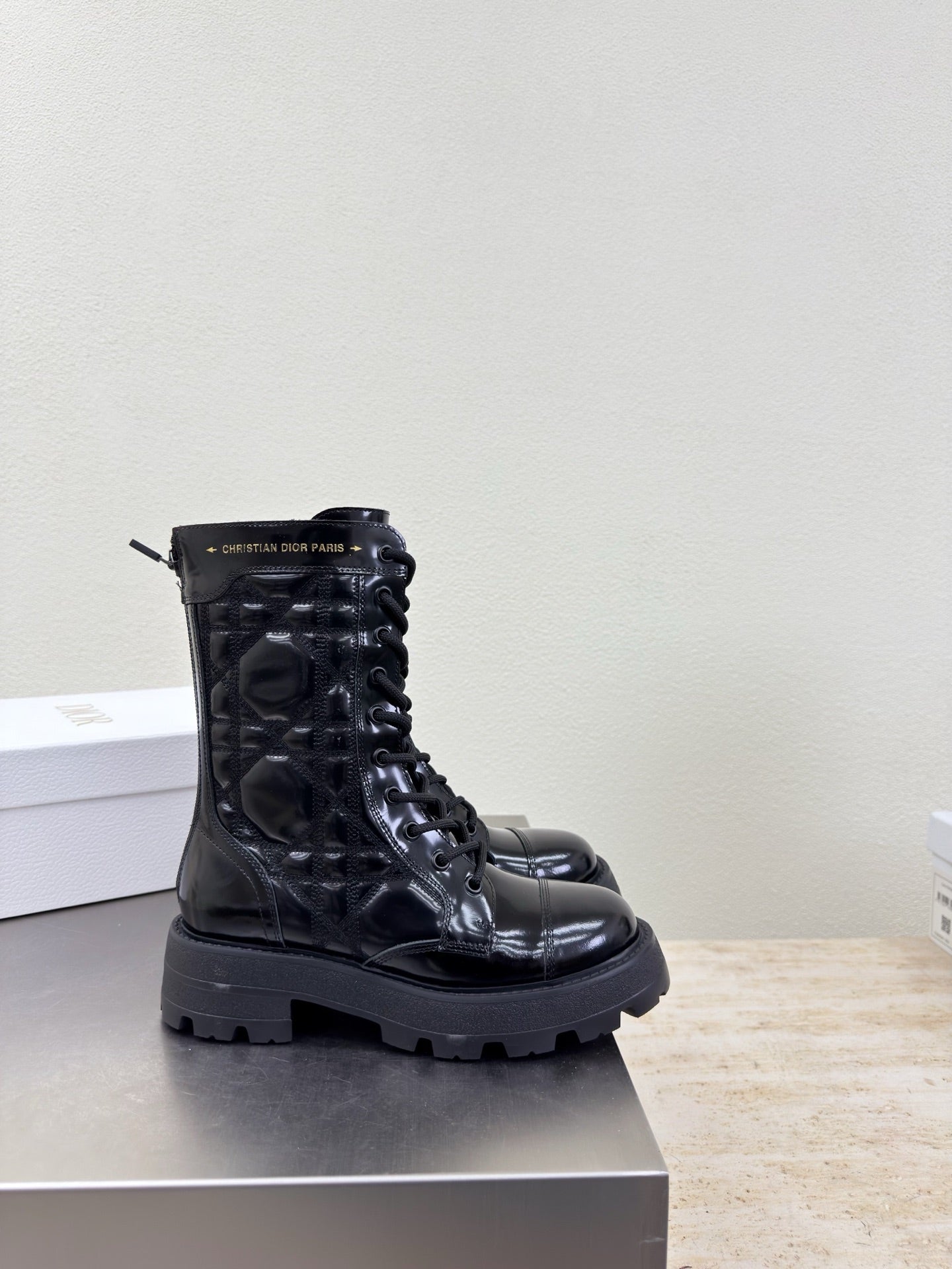 Black glossy lace-up ankle boots with chunky tread sole and eyelets