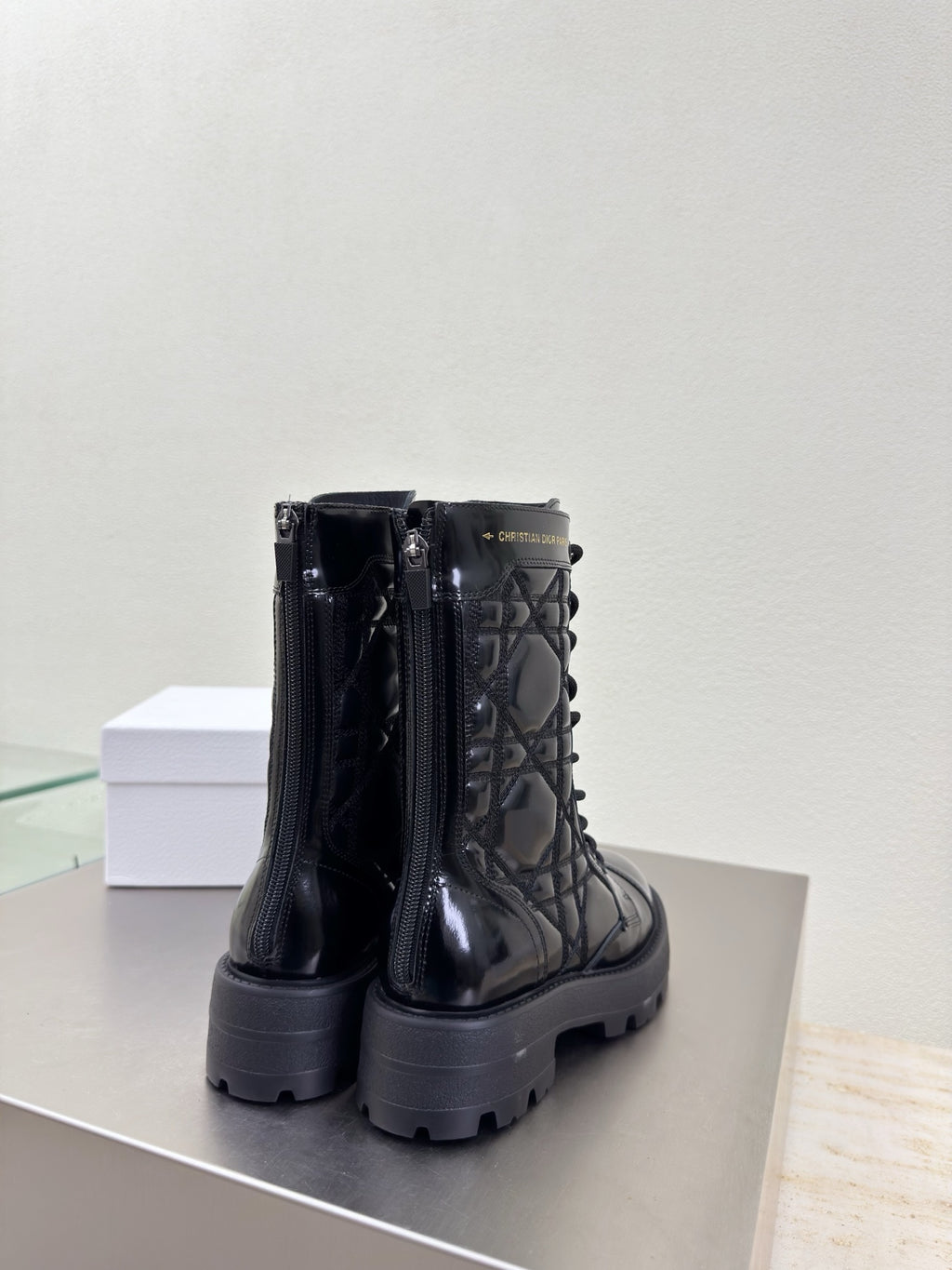 Black glossy combat boots with side zippers and thick platform tread sole