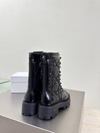Black glossy combat boots with side zippers and thick platform tread sole