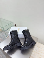 Black lace-up combat boots with textured finish and chunky tread soles